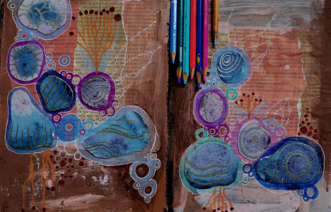 Sketchbook with colored pencils and watercolors