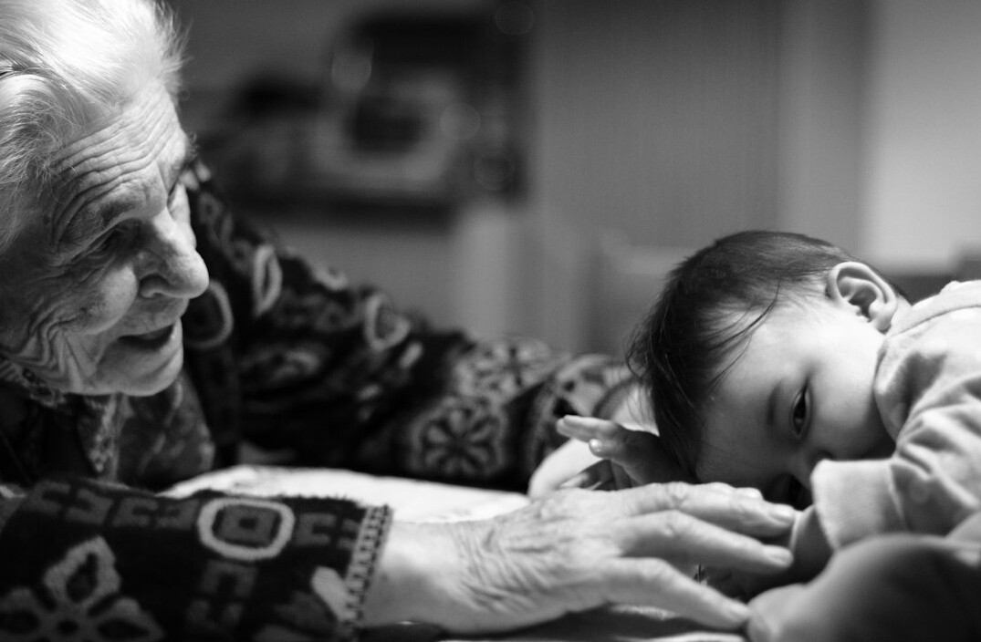 elderly woman knitting with grandchild