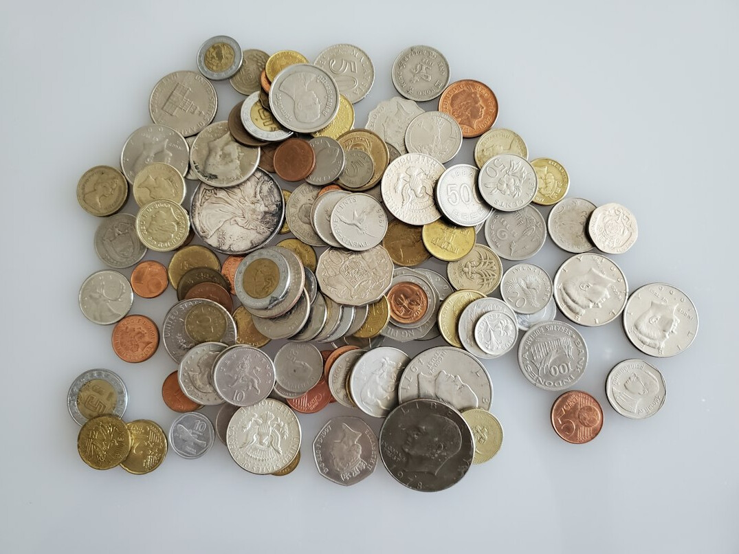 Assorted old coins on a neutral surface