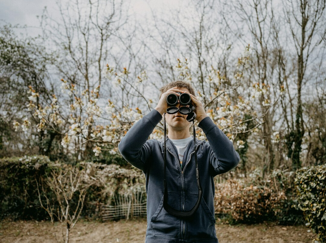 binoculars and bird guide