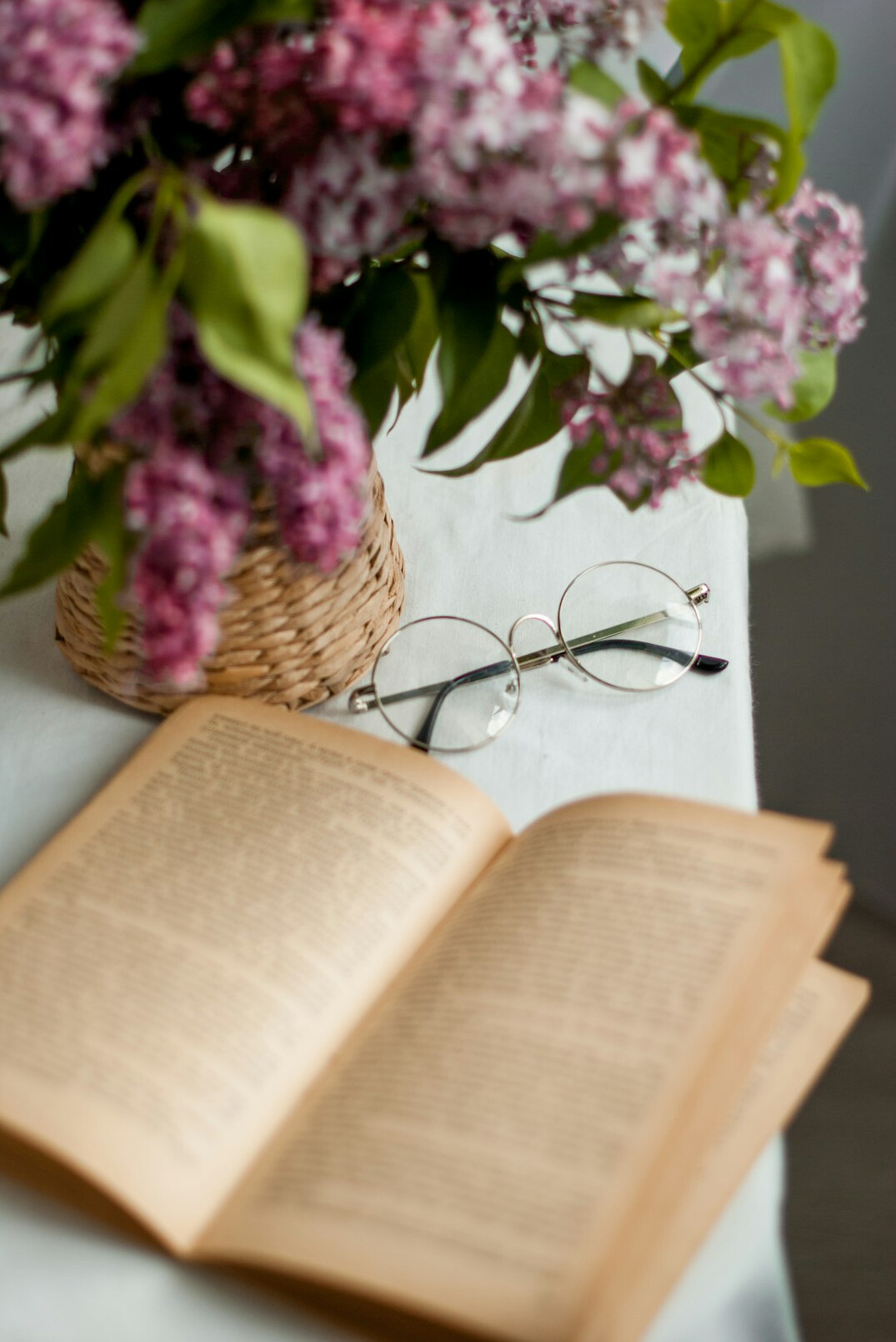 Open book and reading glasses on a table