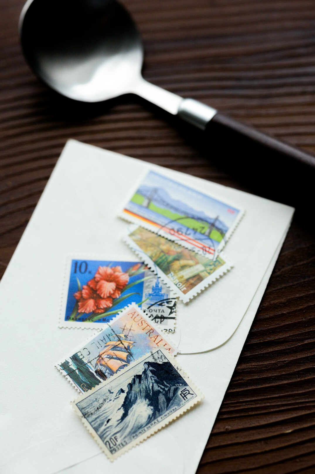 Collection of postage stamps with tweezers and magnifier